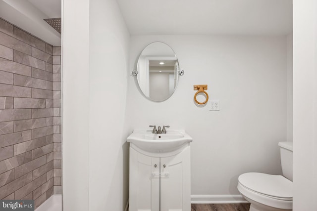 7821 Wendover Ave, Baltimore, MD 21234 - bathroom with a tile shower, vanity, and wood finished floors