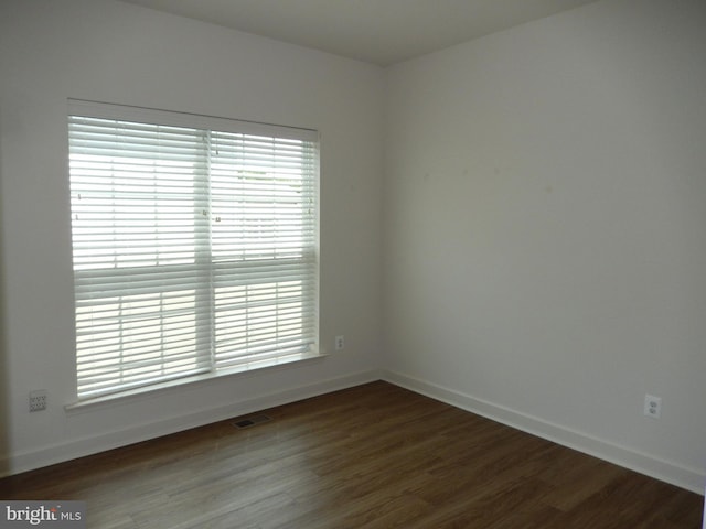 135 Olde Field Dr, Magnolia, DE 19962 - empty room featuring dark wood-style flooring, baseboards, and healthy amount of natural light