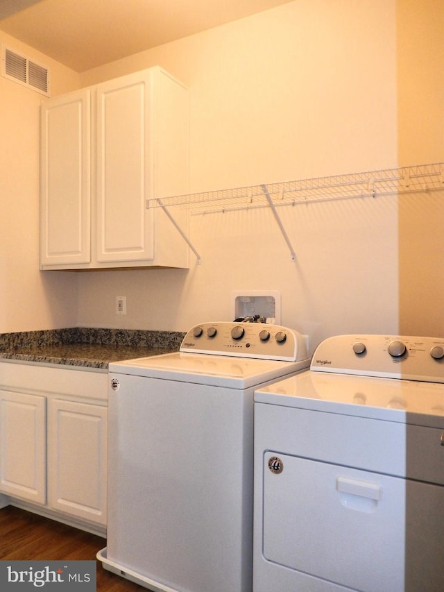 135 Olde Field Dr, Magnolia, DE 19962 - laundry area featuring washing machine and clothes dryer, cabinet space, and dark wood-style flooring