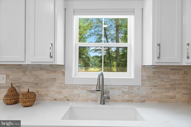 209 S Camden Ave, Fruitland, MD 21826 - kitchen featuring white cabinets, tasteful backsplash, and light stone countertops