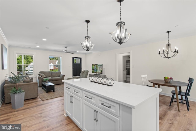 209 S Camden Ave, Fruitland, MD 21826 - kitchen featuring a chandelier, ceiling fan, white cabinetry, light wood-style floors, and ornamental molding