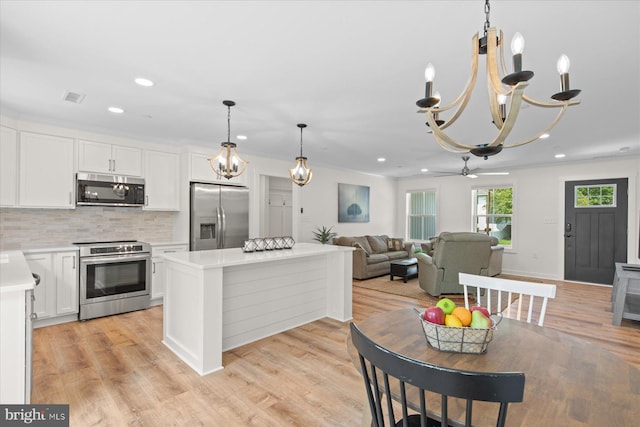 209 S Camden Ave, Fruitland, MD 21826 - kitchen with appliances with stainless steel finishes, light countertops, white cabinets, recessed lighting, and a chandelier