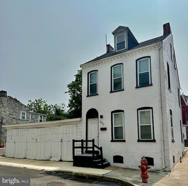 509 E Strawberry St, Lancaster, PA 17602 - view of front facade with brick siding and a chimney
