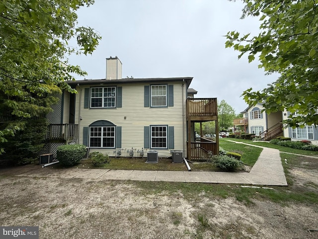 87 Puffin Glade, Bayville, NJ 08721 - back of house with a chimney, a wooden deck, and cooling unit