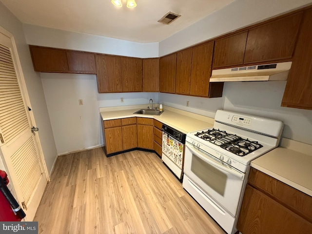 87 Puffin Glade, Bayville, NJ 08721 - kitchen with gas range gas stove, under cabinet range hood, dishwasher, a sink, and light wood-type flooring