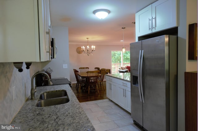 6403 Limerick Ct, Springfield, VA 22152 - kitchen with appliances with stainless steel finishes, a sink, white cabinets, light stone counters, and a chandelier