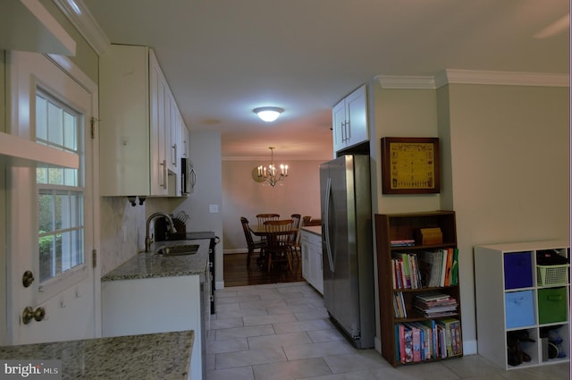 6403 Limerick Ct, Springfield, VA 22152 - kitchen featuring stainless steel appliances, a sink, crown molding, white cabinetry, and a chandelier