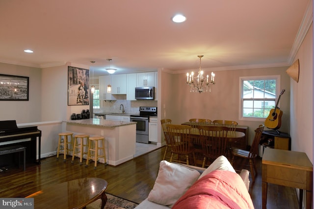 6403 Limerick Ct, Springfield, VA 22152 - living room with a chandelier, dark wood-type flooring, ornamental molding, and recessed lighting