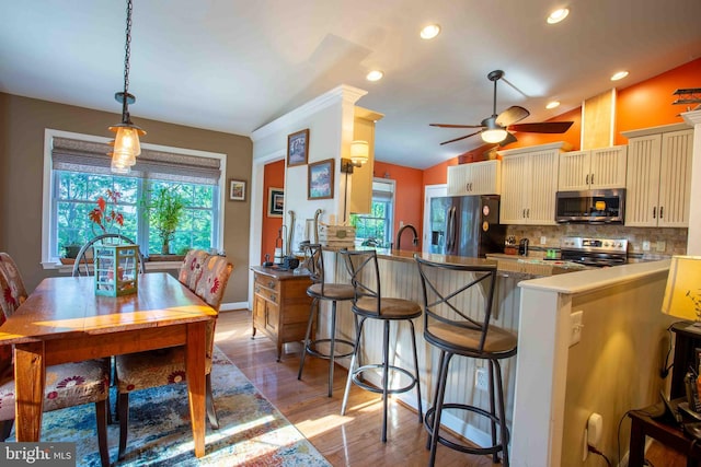 1688 W Commonwealth Dr, Front Royal, VA 22630 - kitchen with stainless steel appliances, plenty of natural light, tasteful backsplash, wood finished floors, and lofted ceiling