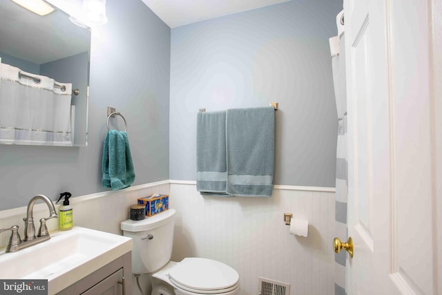 1688 W Commonwealth Dr, Front Royal, VA 22630 - bathroom featuring wainscoting, toilet, and vanity