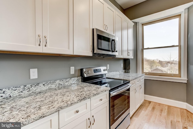 1214 Eutaw Pl, Baltimore, MD 21217 - kitchen featuring stainless steel appliances, baseboards, light wood finished floors, white cabinetry, and light stone countertops