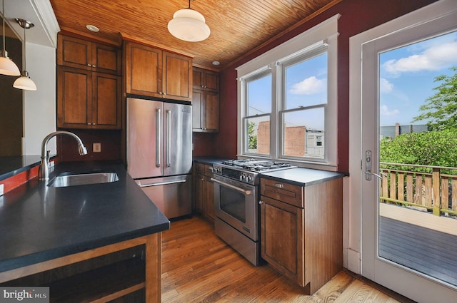 4210 3rd St NW, Washington, DC 20011 - kitchen with appliances with stainless steel finishes, a sink, dark countertops, wooden ceiling, and light wood-style floors