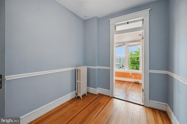 4210 3rd St NW, Washington, DC 20011 - unfurnished room featuring radiator, wood-type flooring, and baseboards