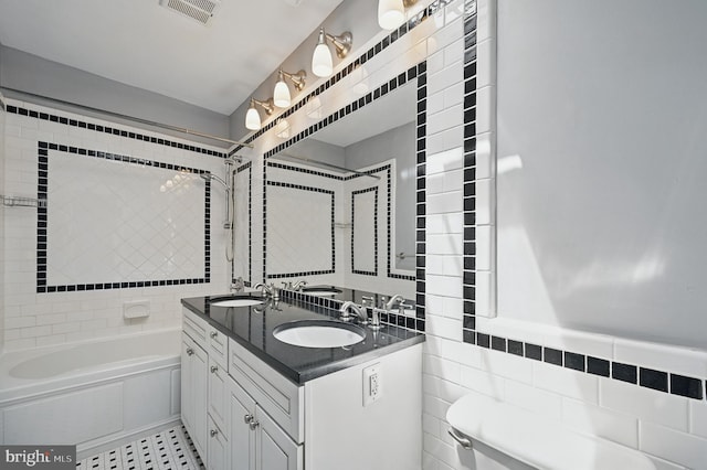 4210 3rd St NW, Washington, DC 20011 - bathroom featuring tile walls, double vanity, toilet, and shower / bath combination