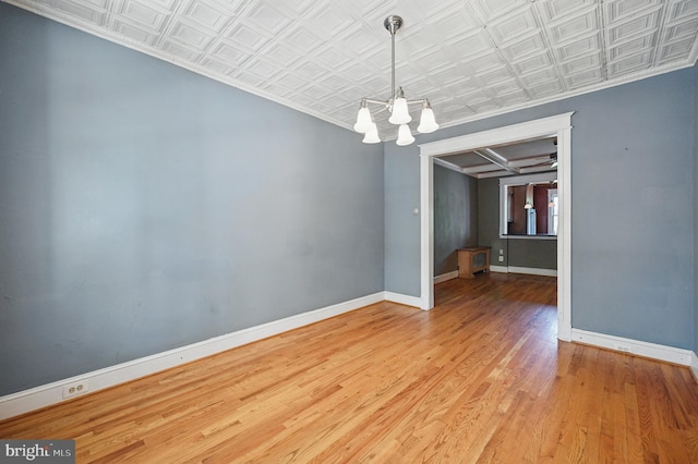 4210 3rd St NW, Washington, DC 20011 - unfurnished room featuring a chandelier, an ornate ceiling, ornamental molding, wood finished floors, and baseboards
