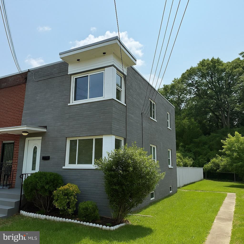 1838 Longford Dr, Hyattsville, MD 20782 - view of side of home with a yard and brick siding