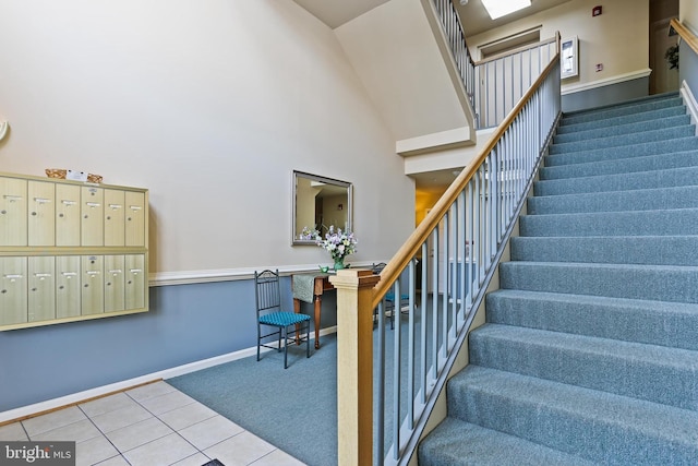 2504 Shelley Cir Unit 1B, Frederick, MD 21702 - stairs featuring a towering ceiling, tile patterned flooring, mail area, baseboards, and carpet