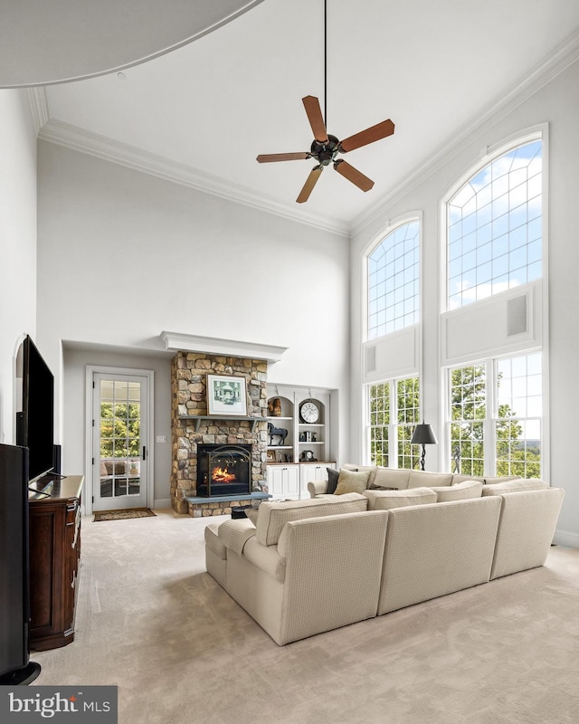 5835 Ridgeview Dr, Doylestown, PA 18902 - carpeted living area with a high ceiling, crown molding, a fireplace, and a ceiling fan