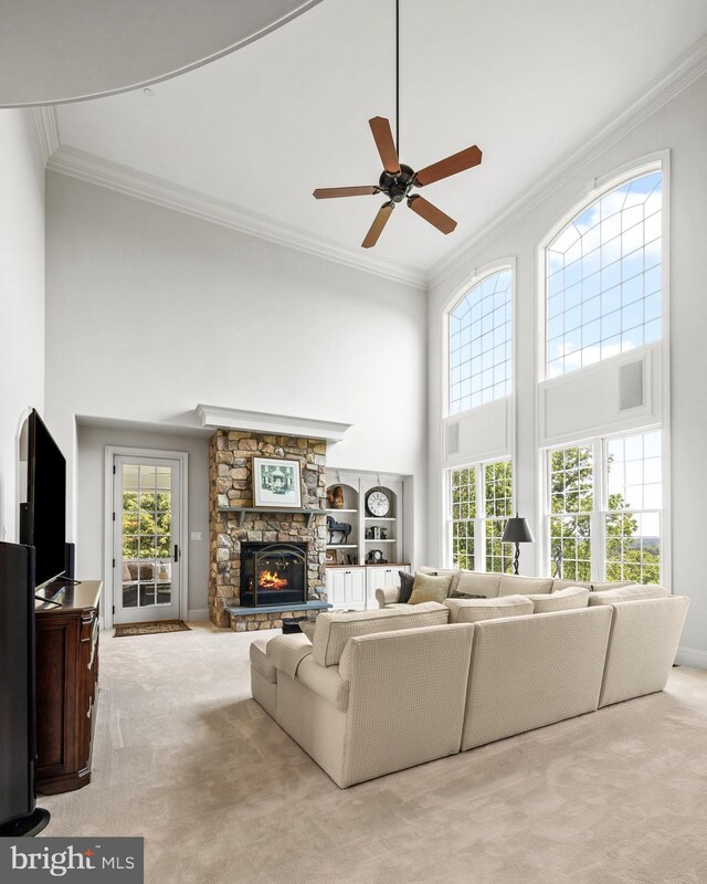 5835 Ridgeview Dr, Doylestown, PA 18902 - carpeted living area with a high ceiling, crown molding, a fireplace, and a ceiling fan