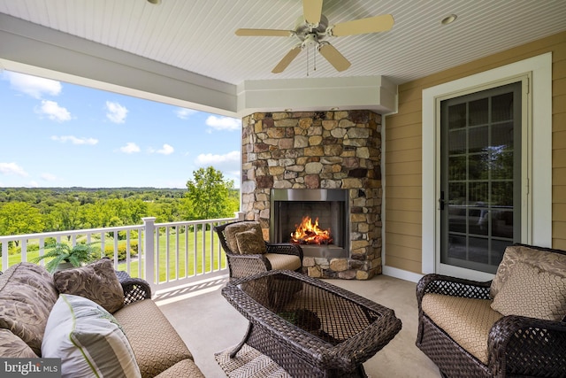 5835 Ridgeview Dr, Doylestown, PA 18902 - view of patio / terrace with an outdoor living space with a fireplace, ceiling fan, and a forest view
