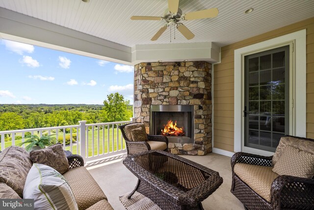5835 Ridgeview Dr, Doylestown, PA 18902 - view of patio with an outdoor living space with a fireplace, a ceiling fan, and a wooded view
