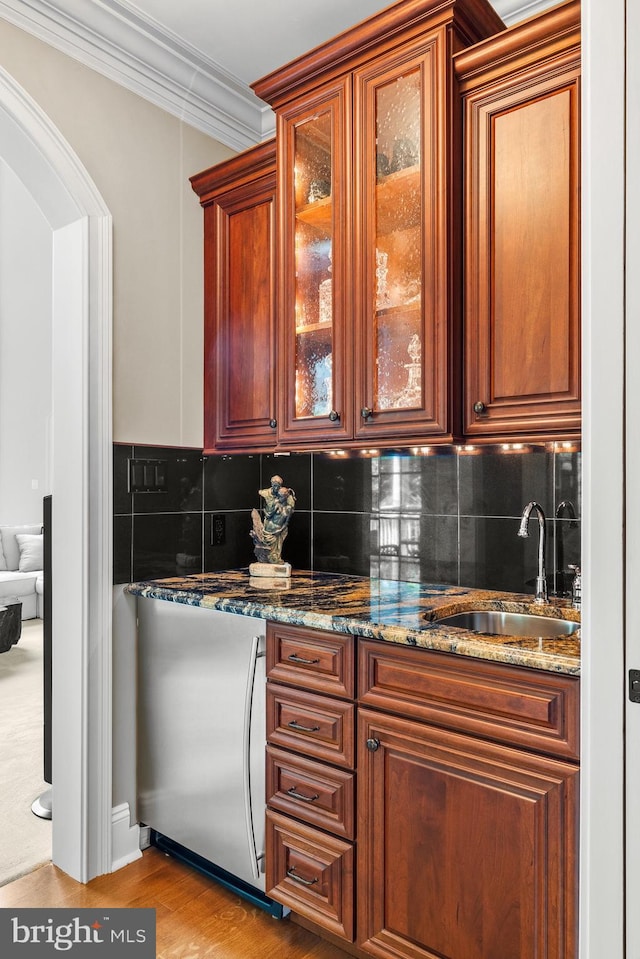 5835 Ridgeview Dr, Doylestown, PA 18902 - kitchen with a sink, decorative backsplash, light wood finished floors, ornamental molding, and glass insert cabinets