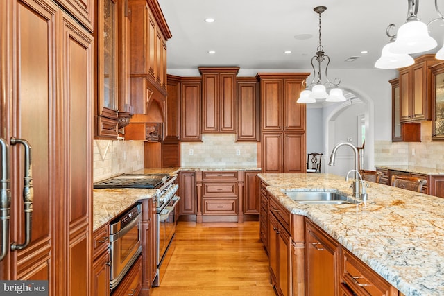 5835 Ridgeview Dr, Doylestown, PA 18902 - kitchen featuring a sink, decorative backsplash, brown cabinets, stainless steel appliances, and recessed lighting