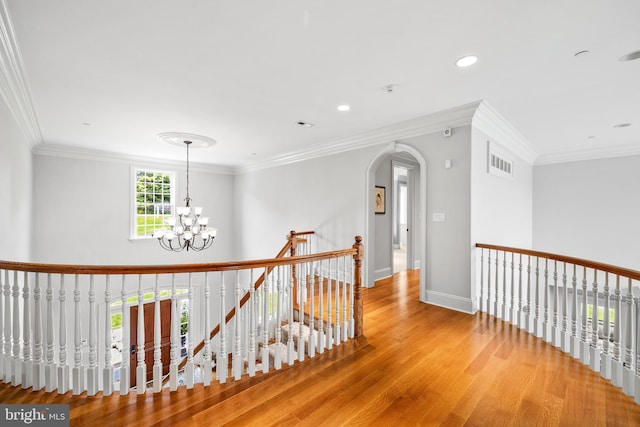 5835 Ridgeview Dr, Doylestown, PA 18902 - corridor featuring wood finished floors, a chandelier, an upstairs landing, crown molding, and baseboards