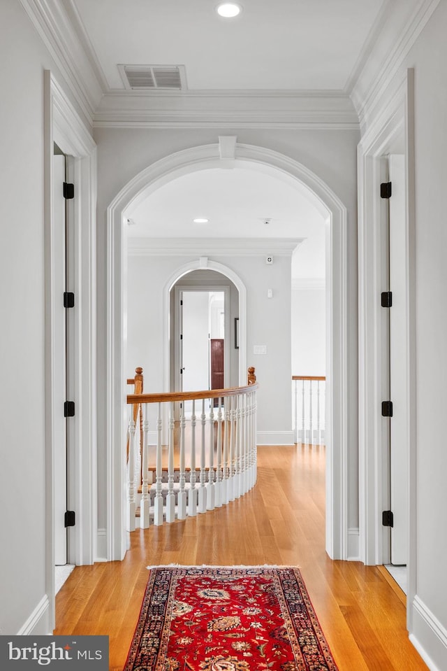 5835 Ridgeview Dr, Doylestown, PA 18902 - hallway with arched walkways, crown molding, light wood-style floors, and recessed lighting