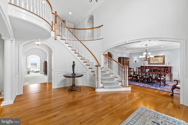 5835 Ridgeview Dr, Doylestown, PA 18902 - foyer featuring stairs, a high ceiling, arched walkways, wood finished floors, and a chandelier