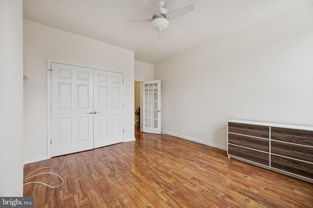 3032 Dillon St, Baltimore, MD 21224 - unfurnished bedroom with wood finished floors, a closet, baseboards, and ceiling fan