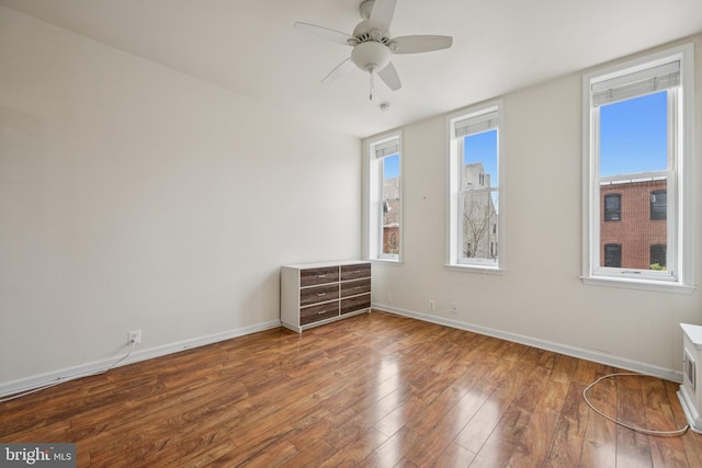 3032 Dillon St, Baltimore, MD 21224 - empty room featuring wood-type flooring, a ceiling fan, and baseboards