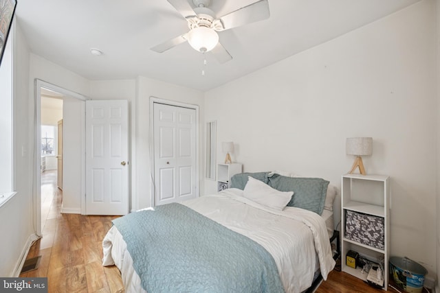 3032 Dillon St, Baltimore, MD 21224 - bedroom with light wood-style floors, a closet, ceiling fan, and baseboards