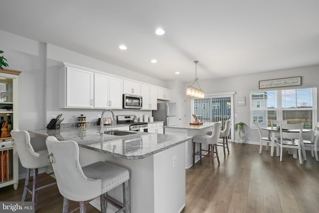 492 Parkland Dr, Stephenson, VA 22656 - kitchen with appliances with stainless steel finishes, a sink, recessed lighting, a breakfast bar area, and a center island