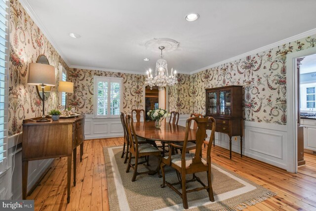 11801 Glen Mill Rd, Potomac, MD 20854 - dining room with wallpapered walls, light wood finished floors, crown molding, a wainscoted wall, and a chandelier
