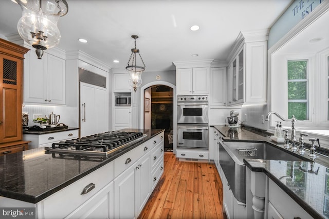 11801 Glen Mill Rd, Potomac, MD 20854 - kitchen featuring appliances with stainless steel finishes, white cabinetry, recessed lighting, light wood-style flooring, and glass insert cabinets