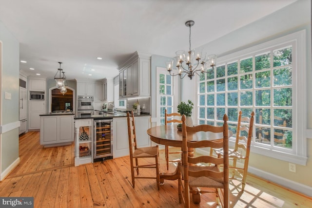 11801 Glen Mill Rd, Potomac, MD 20854 - dining room with beverage cooler, a chandelier, light wood-style floors, baseboards, and recessed lighting