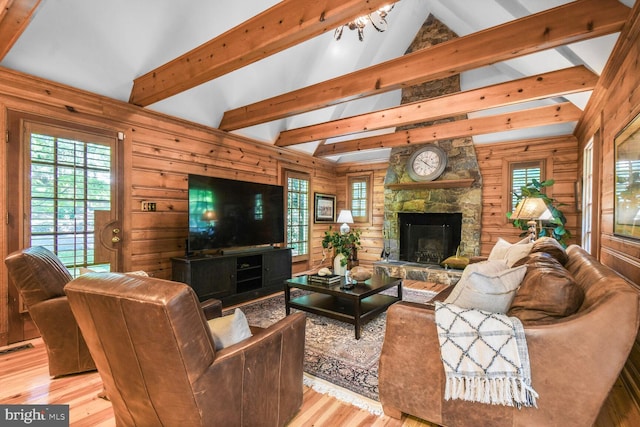 11801 Glen Mill Rd, Potomac, MD 20854 - living area featuring light wood-style flooring, wooden walls, and a stone fireplace