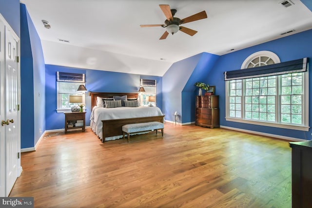 11801 Glen Mill Rd, Potomac, MD 20854 - bedroom featuring wood finished floors, vaulted ceiling, multiple windows, and baseboards