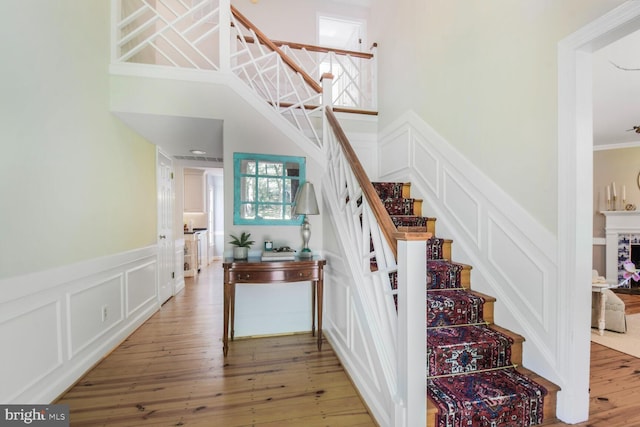 11801 Glen Mill Rd, Potomac, MD 20854 - stairway with a decorative wall, a wainscoted wall, wood-type flooring, and ornamental molding