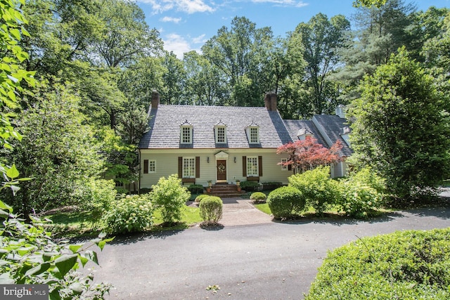 11801 Glen Mill Rd, Potomac, MD 20854 - cape cod house with a chimney, a high end roof, and view of scattered trees