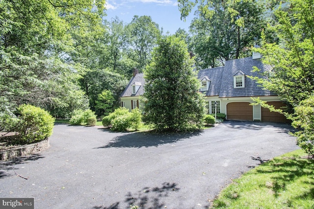 11801 Glen Mill Rd, Potomac, MD 20854 - view of front facade featuring driveway, a chimney, and an attached garage