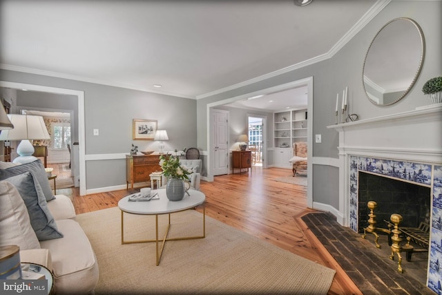 11801 Glen Mill Rd, Potomac, MD 20854 - living area featuring built in shelves, plenty of natural light, light wood-style flooring, a fireplace, and crown molding