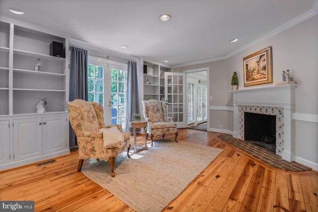 11801 Glen Mill Rd, Potomac, MD 20854 - living area featuring ornamental molding, light wood-type flooring, a tile fireplace, recessed lighting, and baseboards