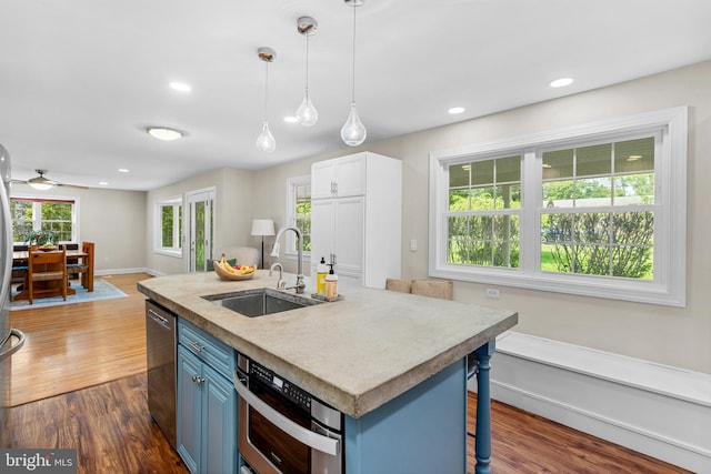 28 New Rd, Doylestown, PA 18901 - kitchen with a sink, blue cabinets, stainless steel appliances, open floor plan, and dark wood finished floors