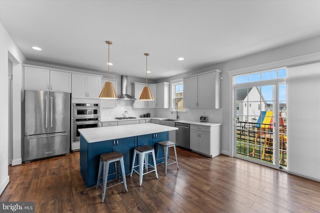 17968 Ridgewood Pl, Round Hill, VA 20141 - kitchen featuring appliances with stainless steel finishes, a sink, a center island, wall chimney range hood, and backsplash