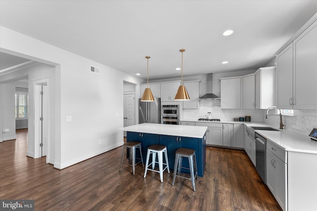 17968 Ridgewood Pl, Round Hill, VA 20141 - kitchen featuring wall chimney range hood, stainless steel appliances, a sink, a kitchen island, and decorative backsplash