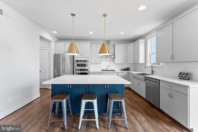 17968 Ridgewood Pl, Round Hill, VA 20141 - kitchen featuring appliances with stainless steel finishes, a center island, wall chimney exhaust hood, a kitchen breakfast bar, and recessed lighting