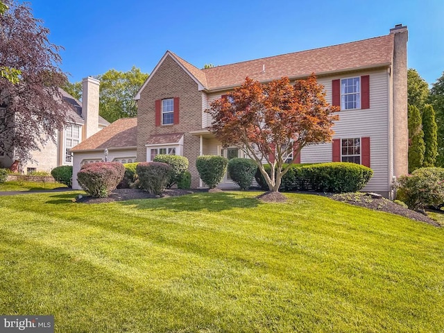 107 Horseshoe Ln, North Wales, PA 19454 - view of front facade with a chimney, a front yard, and an attached garage