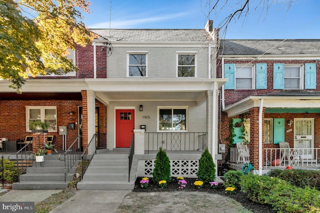1515 Montana Ave NE, Washington, DC 20018 - view of property featuring a porch, brick siding, and a high end roof